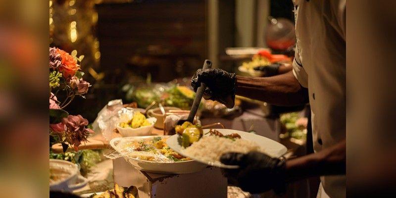 Chef serving Nigerian food at a buffet in Enugu, used as illustrative food-service imagery.
